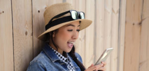 Woman Smiling using Phone