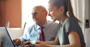 Young girl helps her grandfather place an online order.