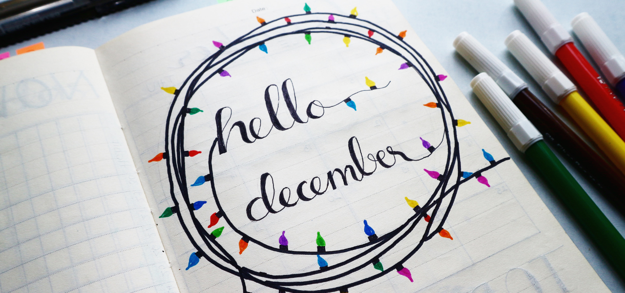 hello december with drawn lights written in marker in a journal