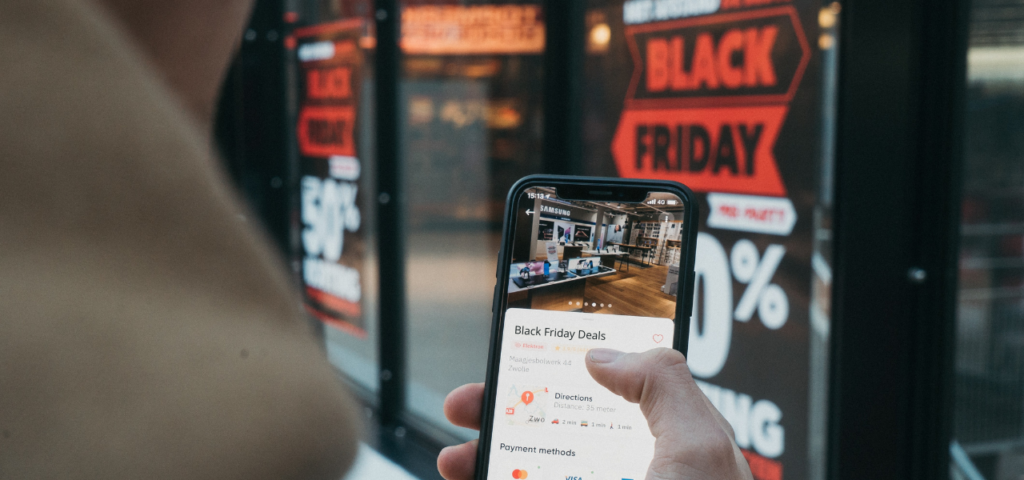 Person using mobile phone to search for Black Friday 2021 deals