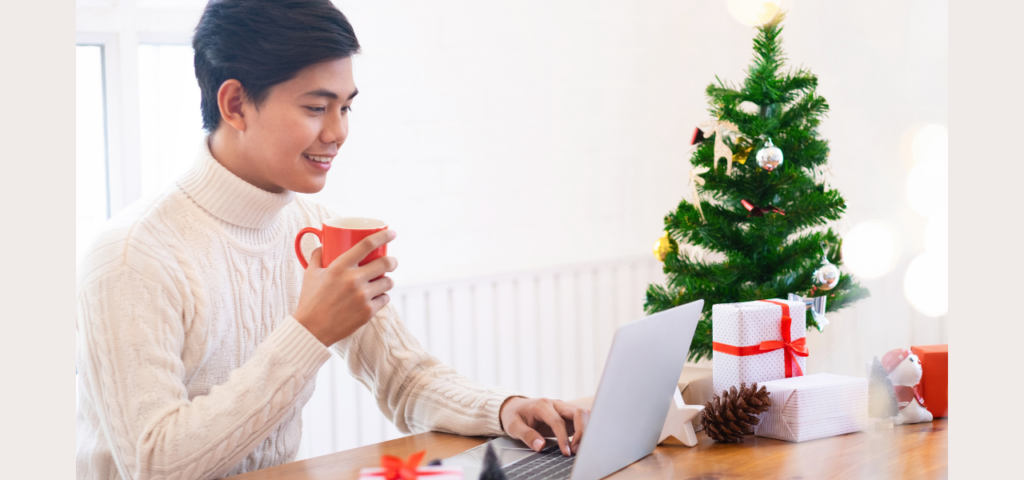 man with coffee online holiday shopping