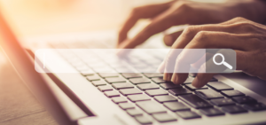 typing on computer behind a search bar