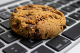 chocolate chip cookie resting on a keyboard