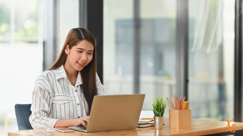 smiling woman working on a laptop