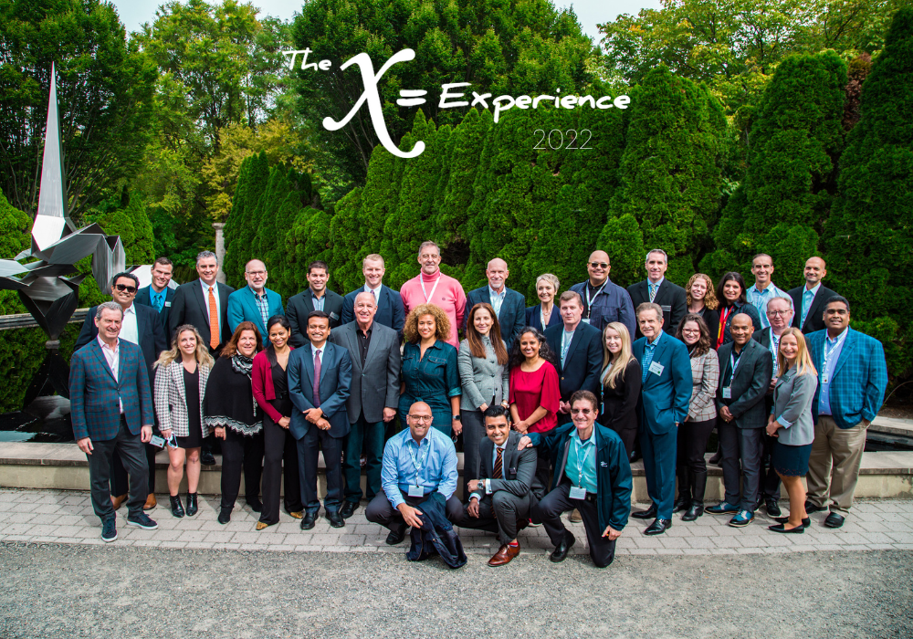 The 2022 X=Experience group photo by the Dorion statue at Grounds for Sculpture