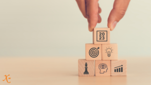 Stacking wooden cubes to put your trends for 2023 strategy into place